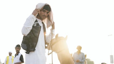 Riders get ready at the track in Dubai International Endurance City for the third edition of the National Day Camel Marathon in Dubai, Saih Al Salam. Reem Mohammed / The National