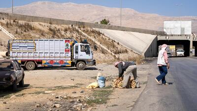 Many Syrians living next to the border earn their daily wage by loading trucks with goods bound for Syria. Thibault Lefébure for The National