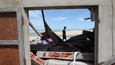 Shrimp farmer Nguyen Van Sa walks past his destroyed warehouse after Typhoon Kalmaegi struck Phu My, Gia Lai Province, central Vietnam. EPA