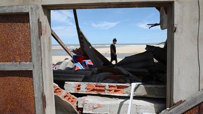 Shrimp farmer Nguyen Van Sa walks past his warehouse destroyed by Typhoon Kalmaegi in Phu My, Gia Lai Province, central Vietnam, 07 November 2025. At least five people were killed after the typhoon struck coastal regions with destructive winds and heavy rain, according to state media. EPA / TIEN DAT