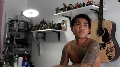 Lawrence Talento, 24, displays his collection of 13 tattoos and says he plans to add more images to his extensive body art. Jeffrey E Biteng / The National