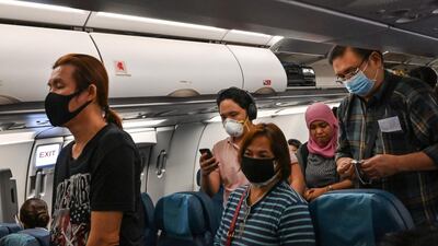 Mask wearing has already become commonplace for airline passengers. AFP