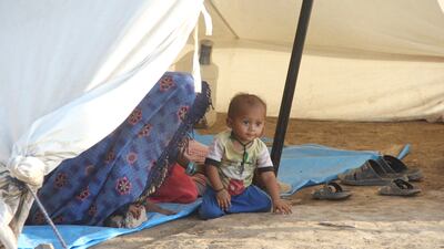 A child displaced by flooding living in a tent city in Hyderabad district, Sindh province, south-east Pakistan. More than 33 million people have been affected nationwide. EPA