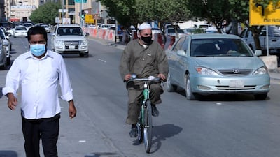 People wear protective masks on a street in the Saudi capital Riyadh on July 5, 2020. Reuters