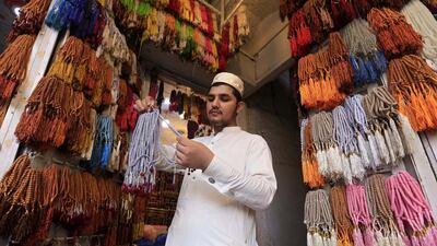 A vendor sells prayer beads at a shop, ahead of Ramadan, in Peshawar, Pakistan. EPA
