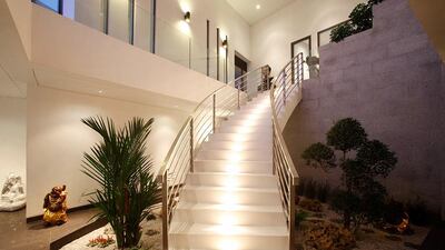 A curving staircase leads to the outdoor areas. Courtesy Signature Residences Worldwide