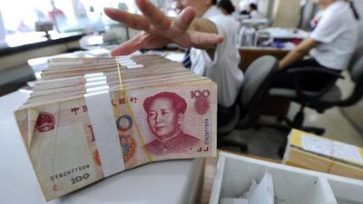 Trade between the UAE and China conducted in the yuan rose 79 per cent last year to 340 million yuan, according to Chinese government data. Above, an employee prepares a bundle of yuan notes at a bank in China. Reuters