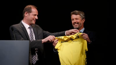Tour de France general director Christian Prudhomme offers a yellow jersey to Crown Prince Frederik of Denmark. EPA