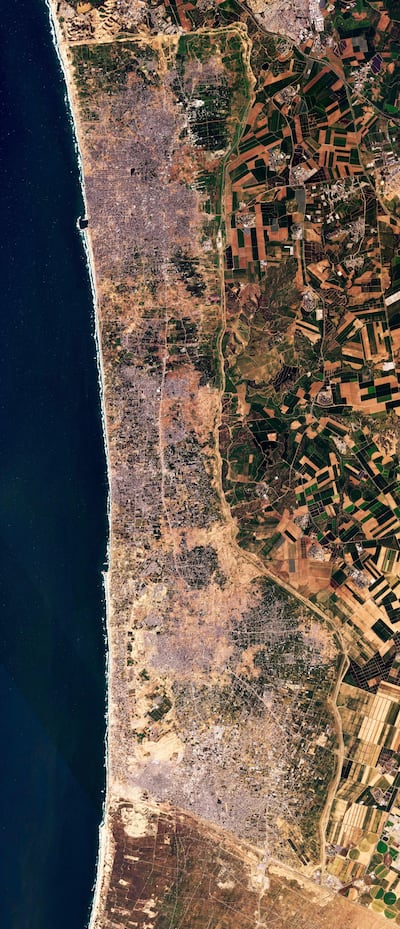 A satellite photo shows the Gaza Strip, including new demolition along a 1km-deep path on the border with Israel. Planet Labs PBC / AP