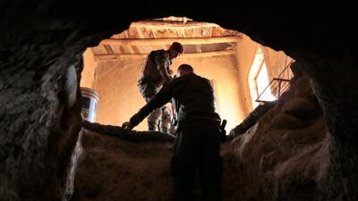 Peshmerga Col Srud Barzinji climbs out of a tunnel dug by ISIL in the village of Khanash, Iraq. Florian Neuhof for The National