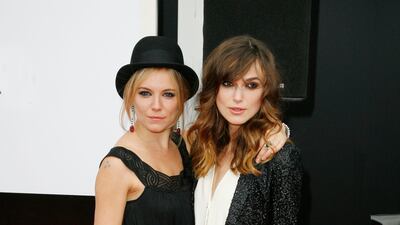 Sienna Miller and Keira Knightley, in a white jumpsuit, attend 'The Edge of Love' screening at Cineworld on June 18, 2008 in Edinburgh, Scotland.