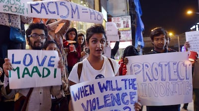 IIndian students stage a vigil in support of Tanzanians who were assaulted by a mob in Bangalore. Maniunath Kiran /AFP