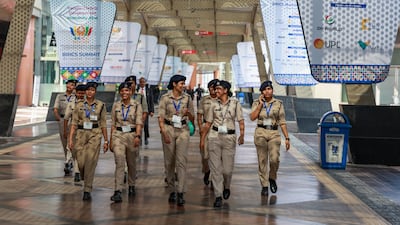 Indian women security personnel walk through the venue for the summit. EPA