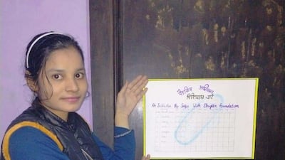 Monika holds the Period Chart that she has put up at her home in Haryana.The chart is an initiative by Sunil Jaglan, a social worker to raise awareness about menstrual health. Taniya Dutta for The National