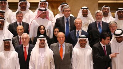 King Juan Carlos of Spain, centre (in grey suit), poses for a group photo with UAE and Spanish participants of the UAE-Spain Economic Forum. Ali Haider / EPA