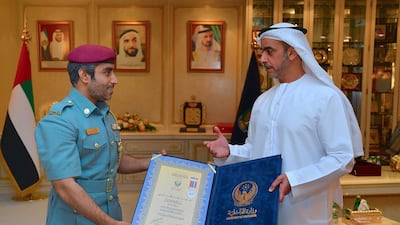 Sheikh Saif bin Zayed awards the Second Class Rescue Medal to First Warrant Officer Rashid Al Raaisi. Courtesy Security Media