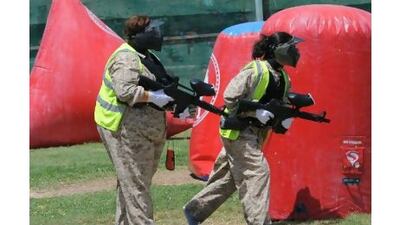 Members of a weight camp get some excerise playing paintball in Kuwait City.