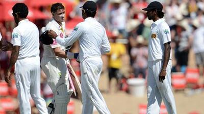 Mike Hussey is congratulated by Sri Lankan cricketers as he walks off the field after the third Test in Sydney.