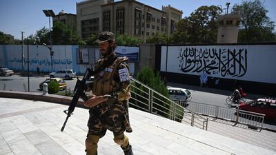 A Taliban fighter stands guard outside the US embassy in Afghanistan. AFP
