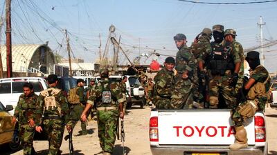 The Iraqi Shiite militia, Kataib Hizbollah, patrols the outskirts of Hibhib in north-east Iraq. Moves to replace the divisive Shiite prime minister Nouri Al Maliki have raised hopes of averting a sectarian war in Iraq. EPA / August 11, 2014