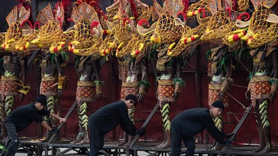 Workers push mannequins dressed in indigenous costumes ahead of independence day celebrations in Manila, the Philippines. AFP