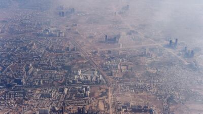 Smog envelops buildings on the outskirts of the Indian capital New Delhi. Roberto Schmidt / AFP