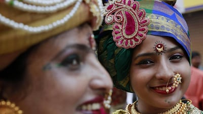 Indian women dressed in traditional attire pose for photos during a procession to mark “Gudi Padwa”, or the Marathi new year, in Mumbai, India. Rafiq Maqbool / AP