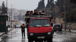 An overloaded lorry carries residents fleeing fighting between government troops and SDF fighters in Aleppo. Reuters