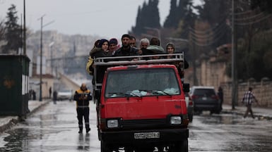An overloaded lorry carries residents fleeing fighting between government troops and SDF fighters in Aleppo. Reuters