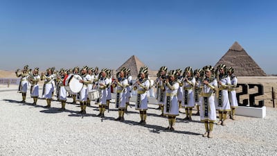 Marching band members dressed in ancient Egyptian clothing.