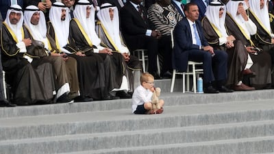 A young boy sits next to officials on France’s national day, which marks the storming of the Bastille in 1789, giving rise to the French Revolution. AP
