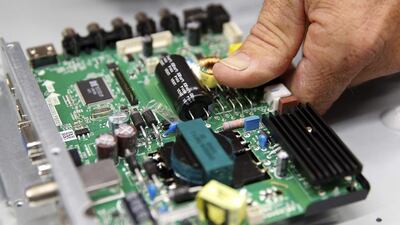A worker lines up the motherboard as he assembles a 32-inch TV at Element Electronics in Winnsboro, South Carolina. Element previously made all its TVs in Asia - but it was unable to get them on Walmart's shelves because there was nothing that differentiated them from rivals' products. Today, Element's 32- and 40-inch TVs that are now available in all of Walmart’s more than 4,000 US stores. Chris Keane / Reuters