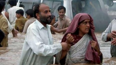 Villagers seek higher ground near Nowshera yesterday.