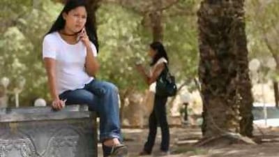 A woman calls her family near a hotel in the Oman border town of Buraimi.