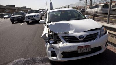 A car involved in an accident on the side of Sheikh Zayed Road. Some insurers give discounts to accident-free clients. Christopher Pike / The National