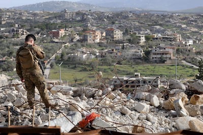A Lebanese soldier stands guard during a visit by Prime Minister Nawaf Salam to the heavily-damaged southern village of Kfar Kila, destroyed by the Israeli military, near the border with Israel on February 8, 2026. AFP