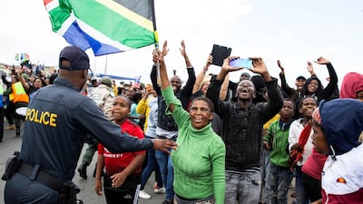 People cheer as South African Rugby World Cup winner team parades on an open top bus. AFP