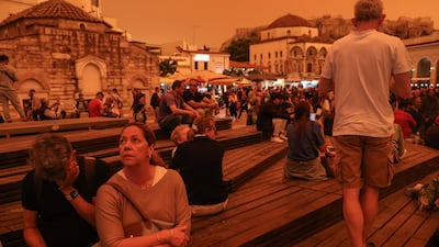 People stroll while African dust covers the sky of Athens, Greece, 23 April 2024. According to the National Observatory of Athens, the atmospheric circulation over Greece favors the transfer of warm air masses from Africa to Greece, resulting in very high temperatures and the transfer of significant amounts of Saharan dust. EPA / GEORGE VITSARAS