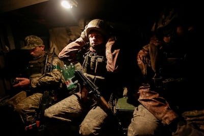 Ukrainian soldiers inside a Bushmaster armoured vehicle near the front line city of Bakhmut. Reuters