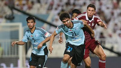 Baniyas' Mohamed Jaber, No 21, jostles with Sebastian Tagilabue, right, of Al Wahda during their Arabian Gulf League match on September 26, 2014. Delores Johnson / The National