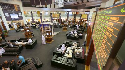 Traders go about their business on the Dubai Financial Market. The DFM gained 3.5 per cent today. Pawan Singh / The National