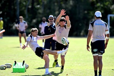Tate McDermott kicks the ball as Cadeyrn Neville attempts to charge it down during an Australian Wallabies training session. Getty Images