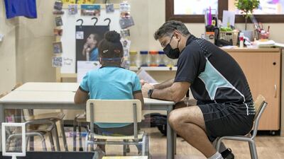 A teacher helps a pupil duirng a one-to-one session.
