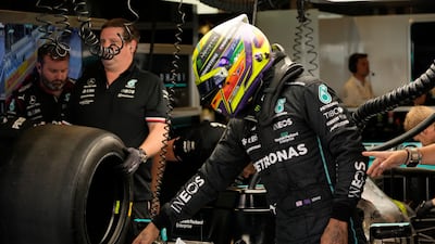 Mercedes driver Lewis Hamilton of Britain talks to mechanics during practice. AP Photo