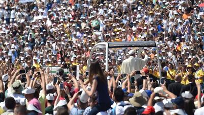 Pope Francis gives his blessing to thousands of the faithful, cheering his arrival in the popemobile to celebrate a mass at Sarajevo's city stadium on June 6, 2015. Andrej Isakovic/AFP Photo