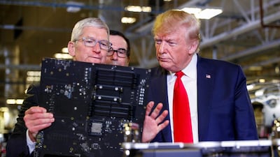 Apple CEO Tim Cook escorts U.S. President Donald Trump as he tours Apple's Mac Pro manufacturing plant with Treasury Secretary Steven Mnuchin looking on. Reuters