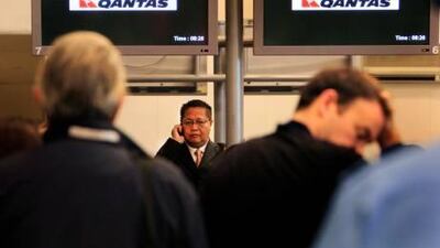 Passengers from the grounded Qantas Airbus A380 plane check-in on flights arranged to take them home at the Changi International Airport in Singapore.