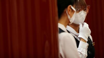 Staff members wear protective face shields, as well as masks. Reuters