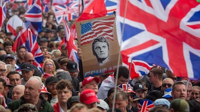 Protesters in London display a placard bearing the image of American far-right commentator Charlie Kirk. EPA