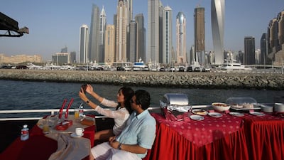 A couple selfies on a cruise dhow opposite of Dubai Marina waterfron. Kamran Jebreili / AP Photo